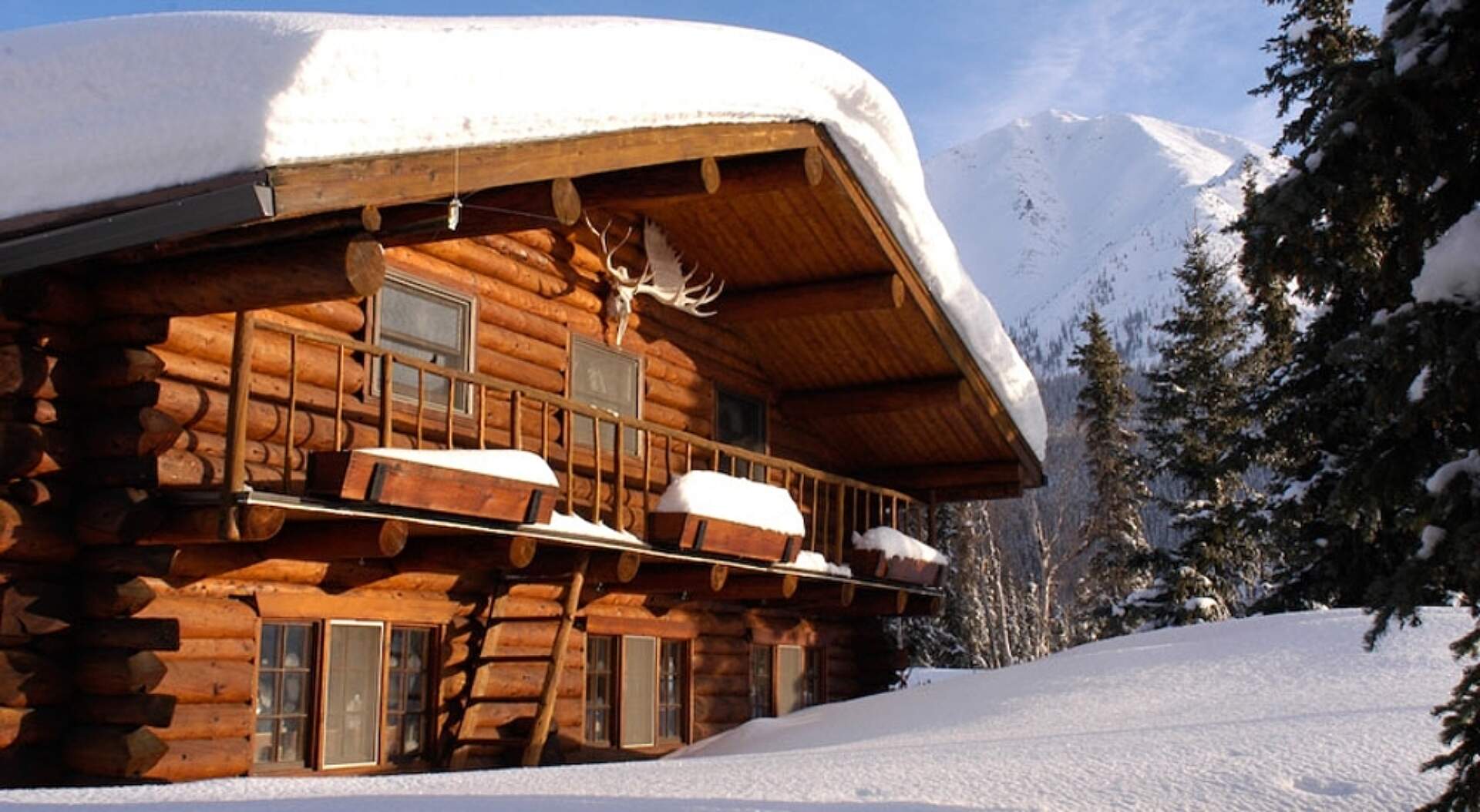 View of Iniakuk Lake Widlerness Lodge in the winter, covered in snow